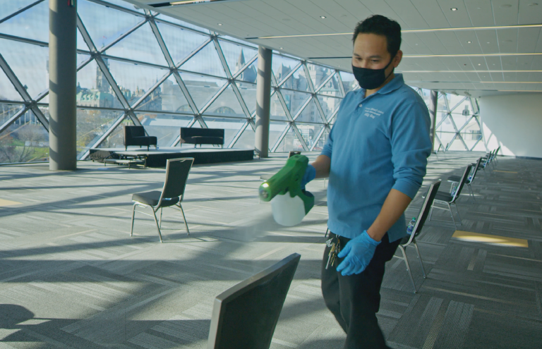 Shaw Centre staff member cleaning chair