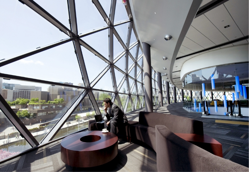 Interior of the Shaw Centre with a man sitting on a couch.