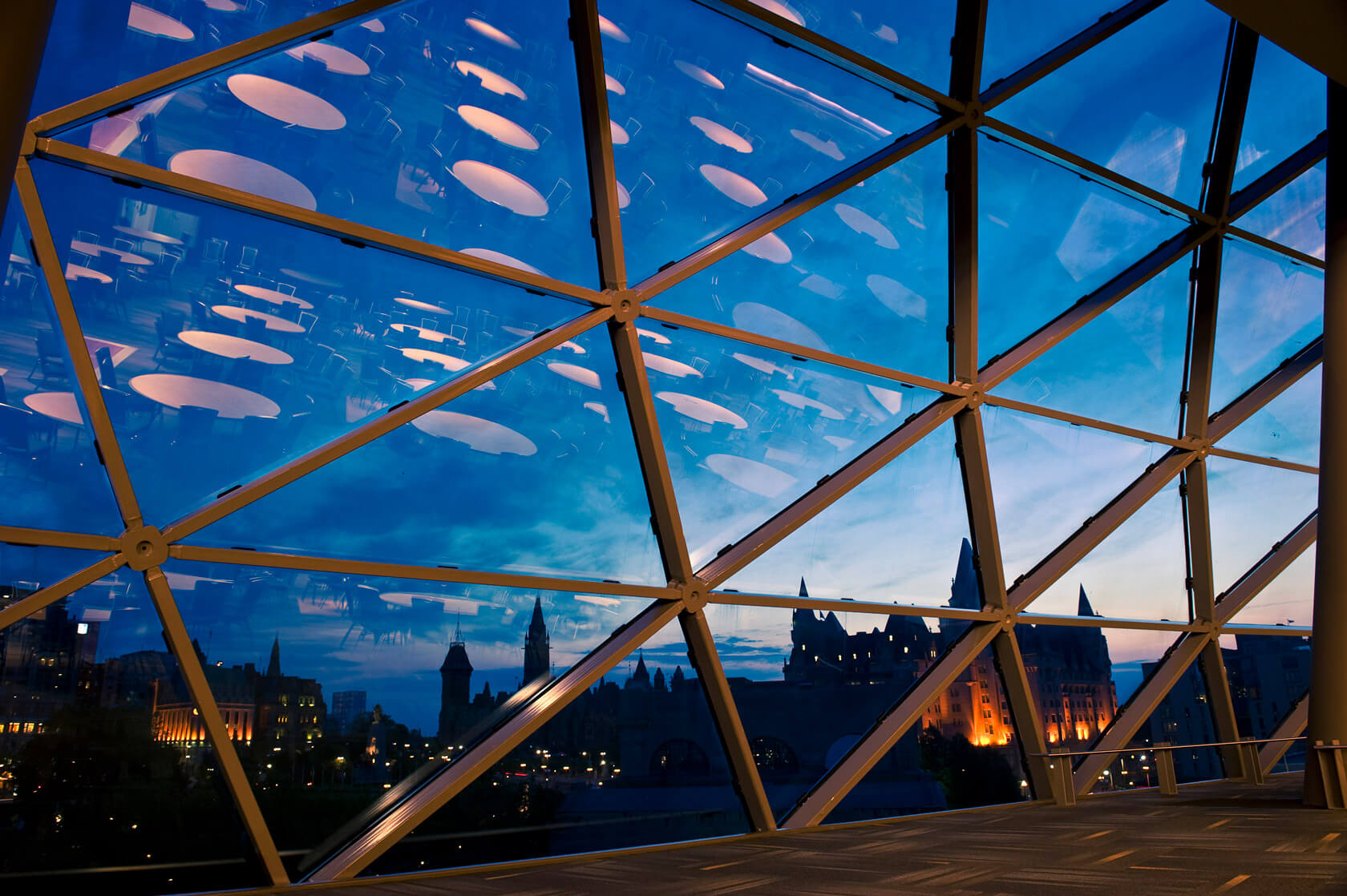 Overlooking the Parliament and Chateau Laurier at sundown through the Shaw Centre windows.