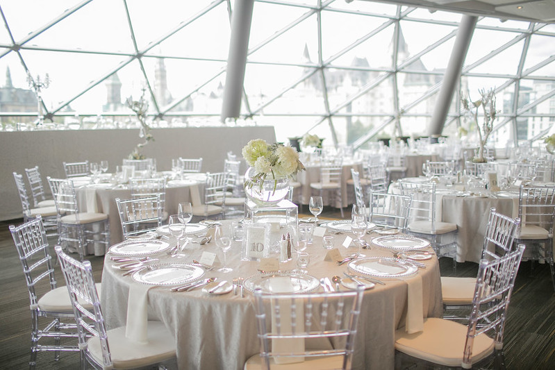 Tables and chairs are set for a wedding reception.