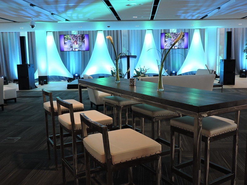 A table with high chairs is set for an event.