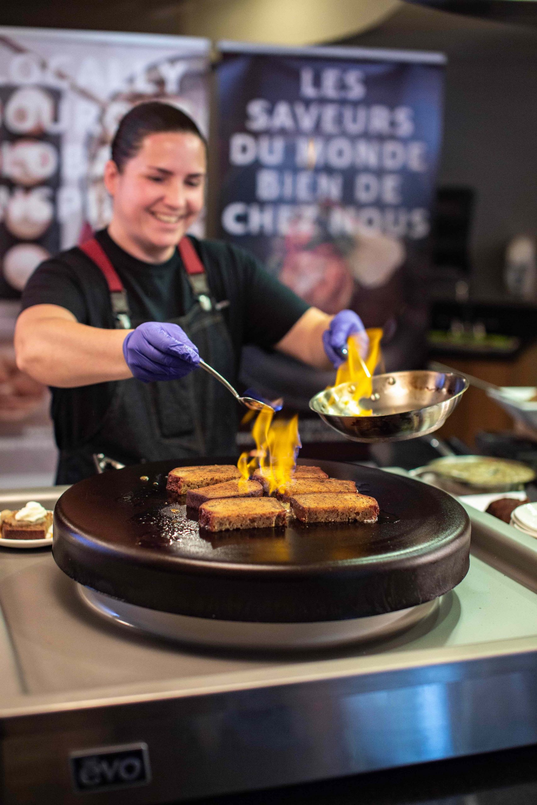 Sous-Chef Sands flambes a dish on a stovetop.