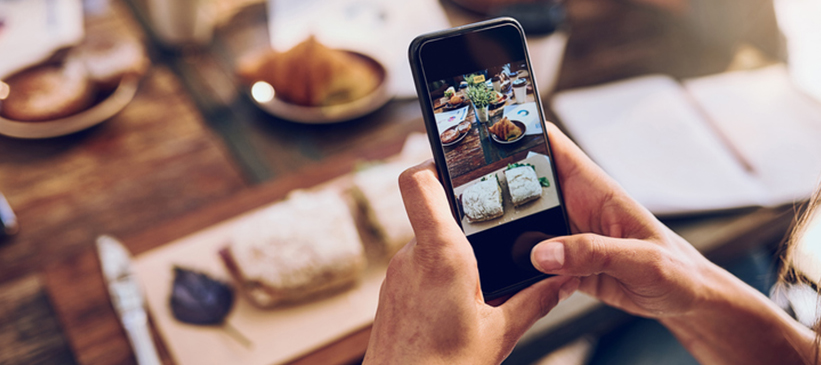 Someone taking photo of food with phone