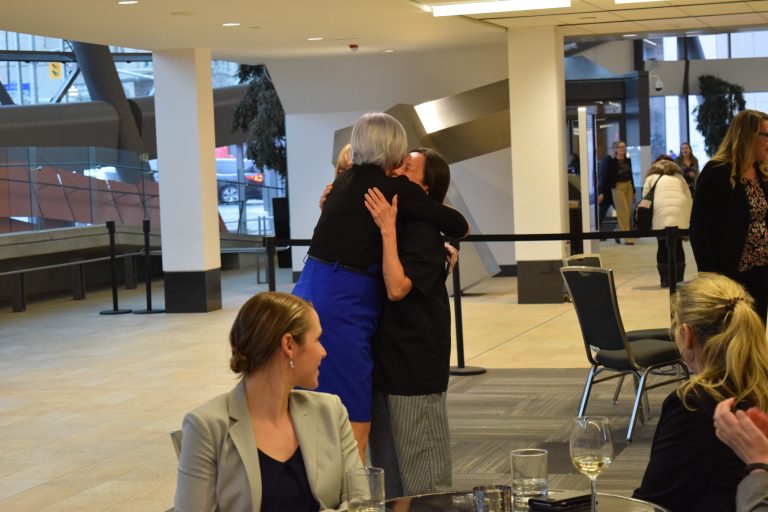 Nina Hugging Employee
