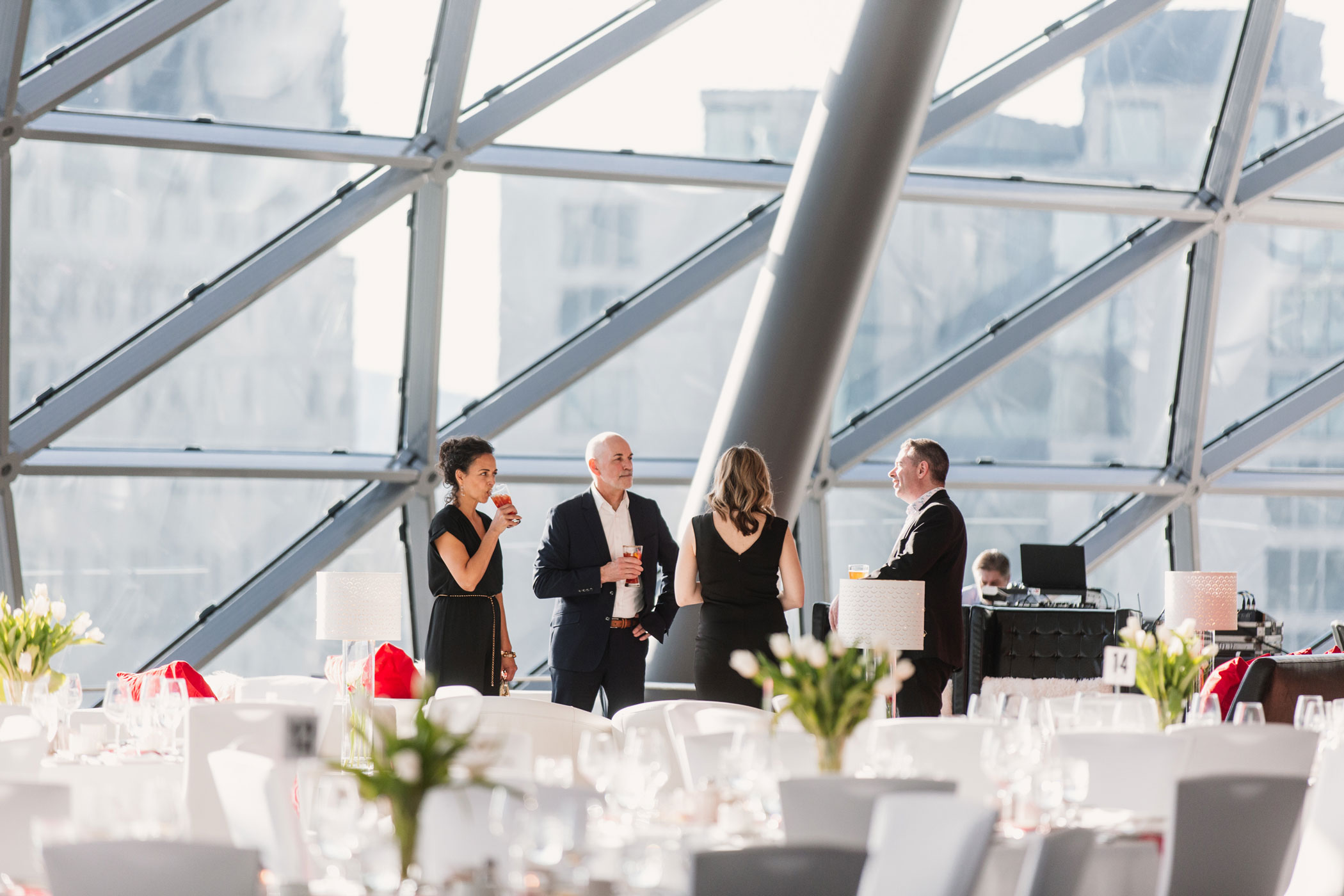 A group of four people gather before an event.