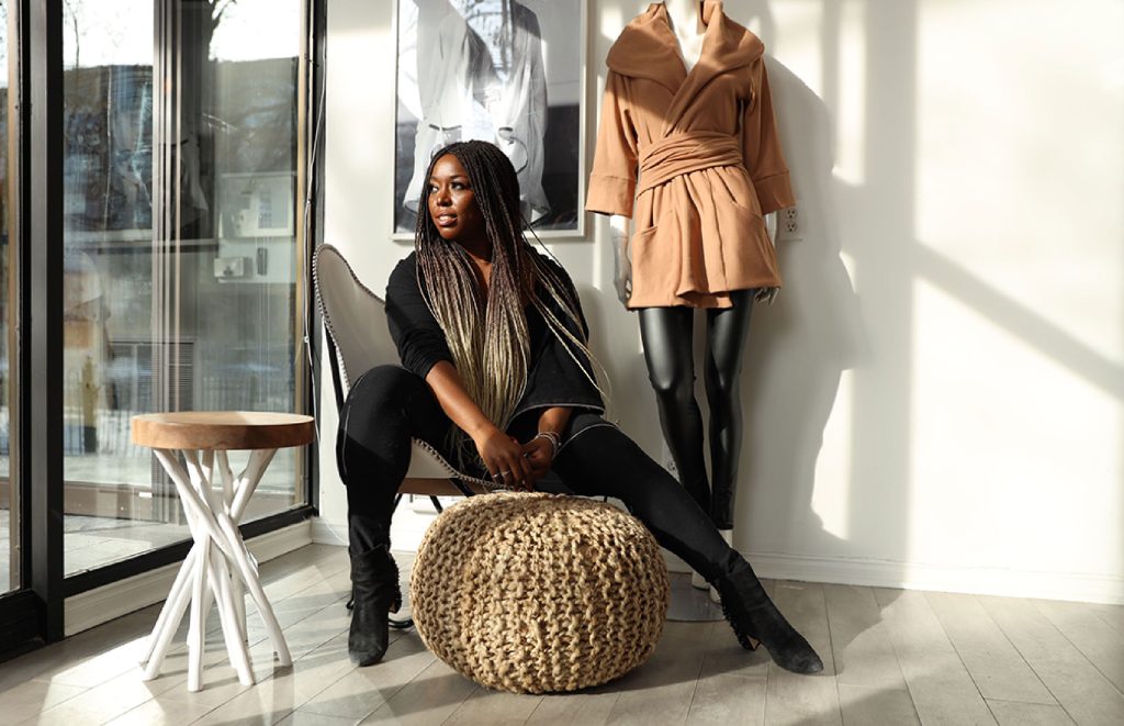 Stacey Martin poses next to a fashion mannequin.