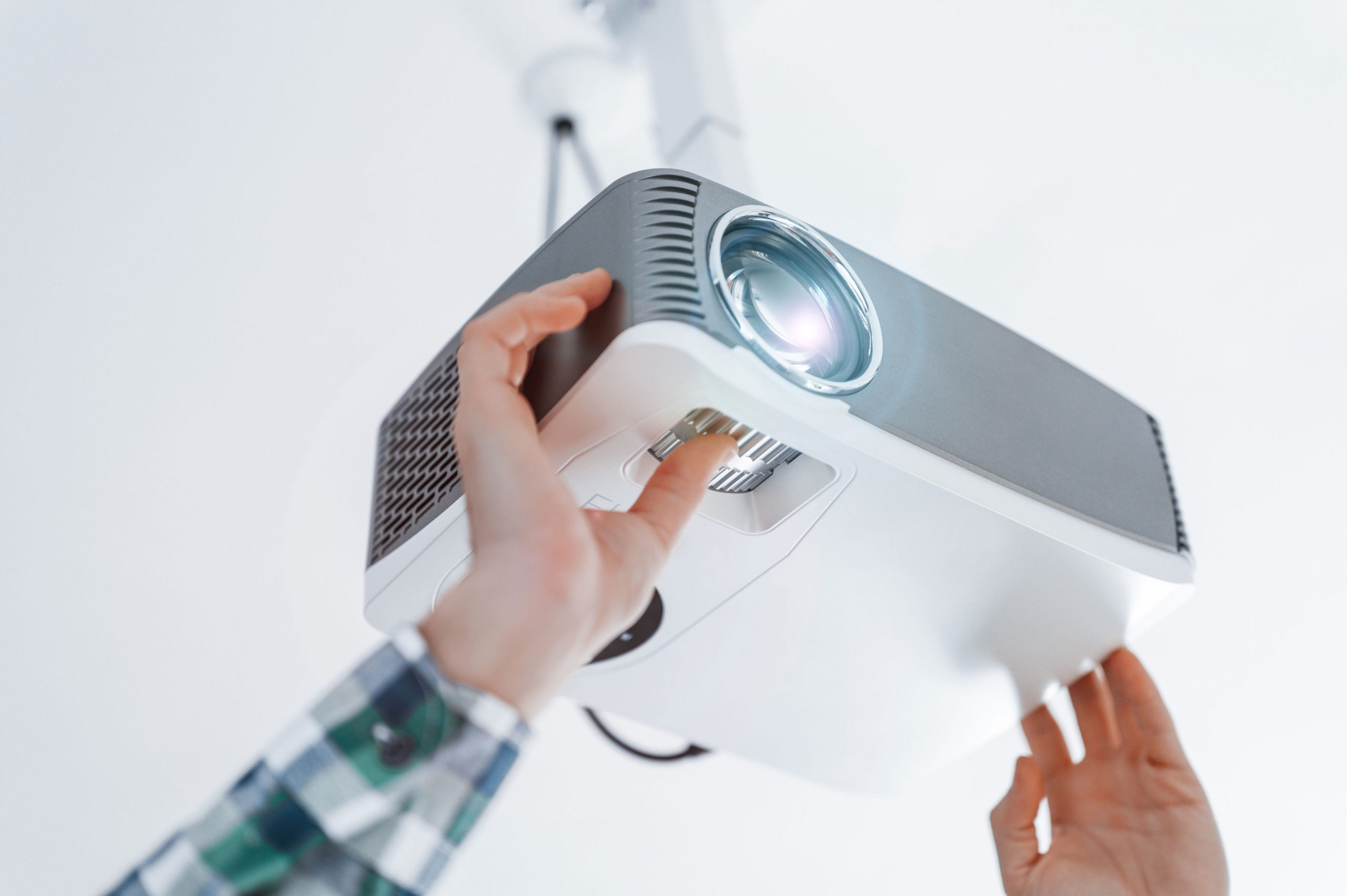 A person sets up a projector.