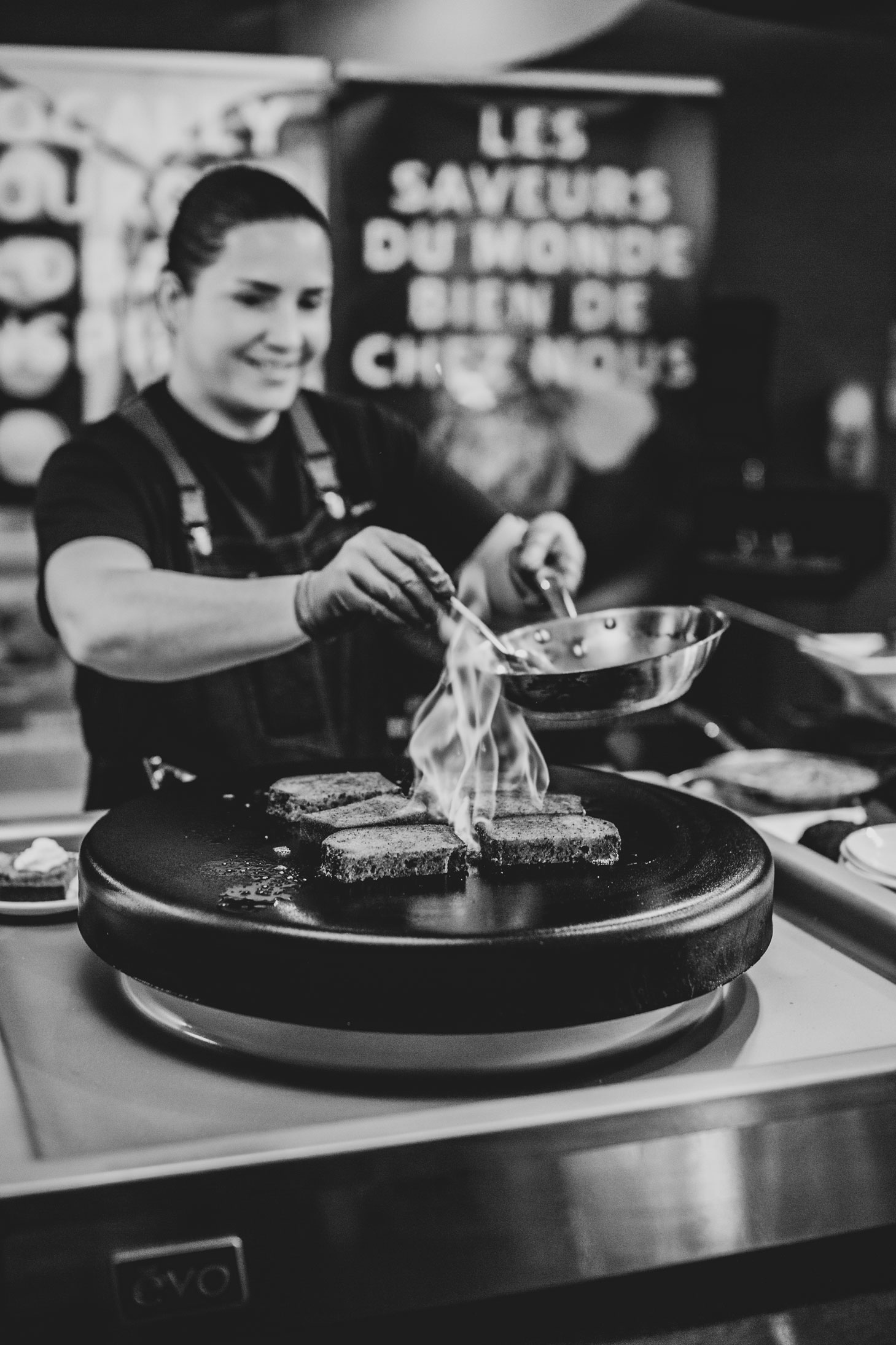 A cook flambés food.