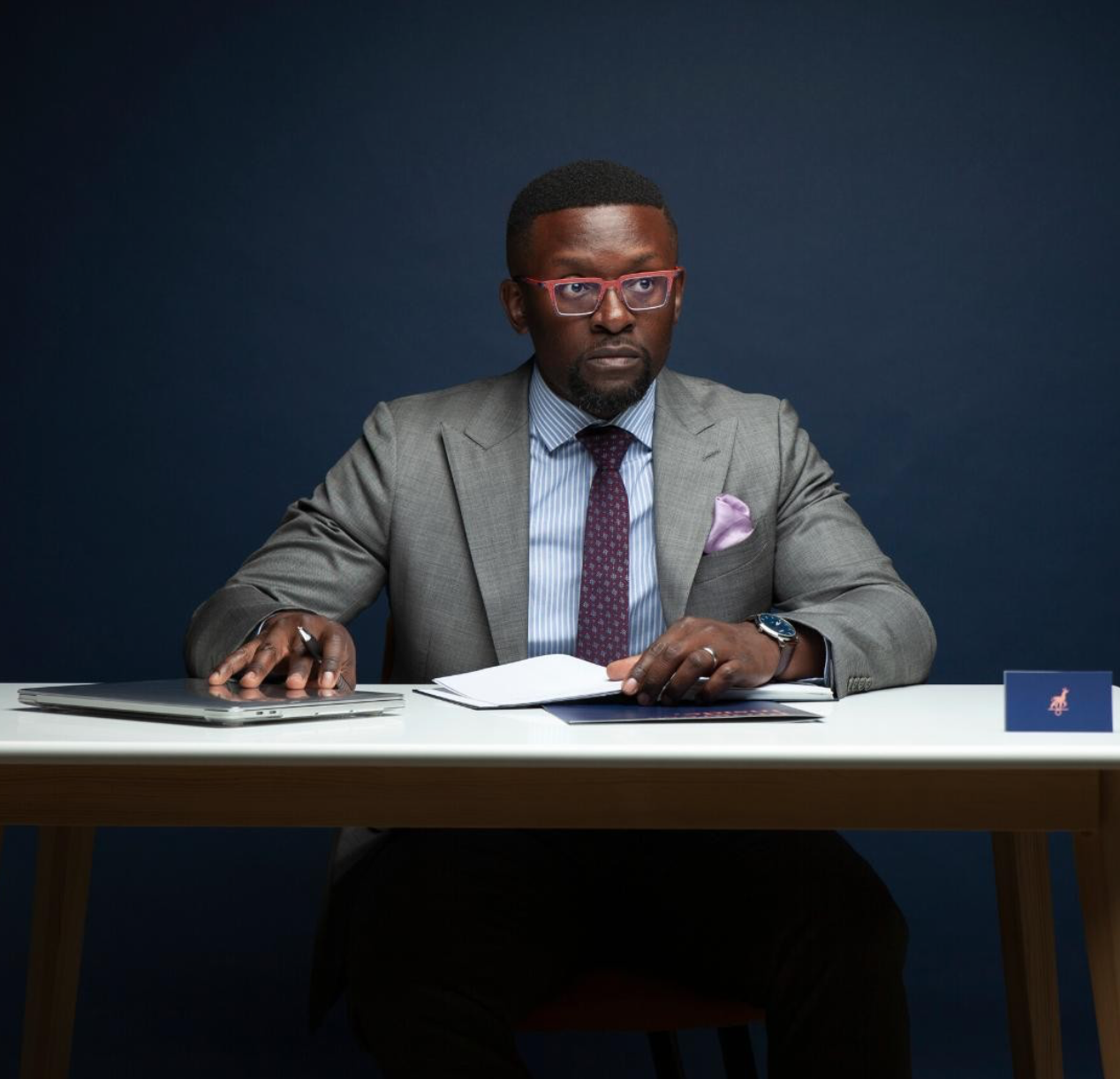 Man sitting at a desk with a book